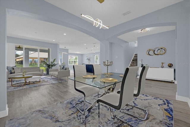 dining area featuring hardwood / wood-style flooring and an inviting chandelier