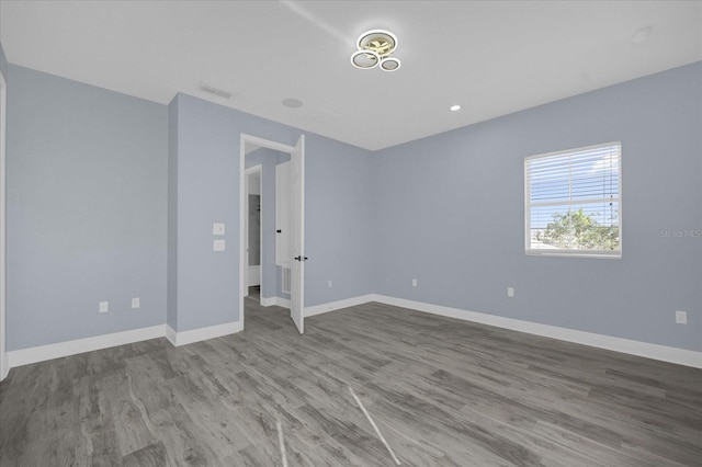 spare room featuring wood-type flooring