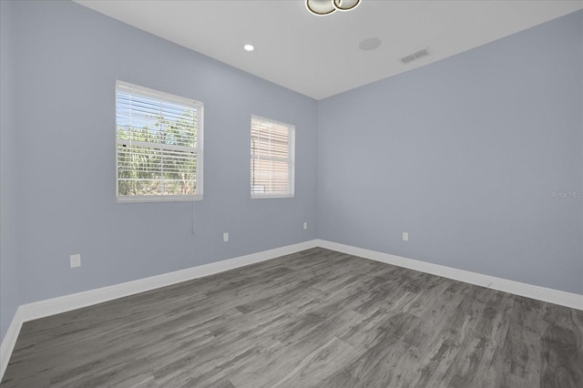 unfurnished room with hardwood / wood-style flooring