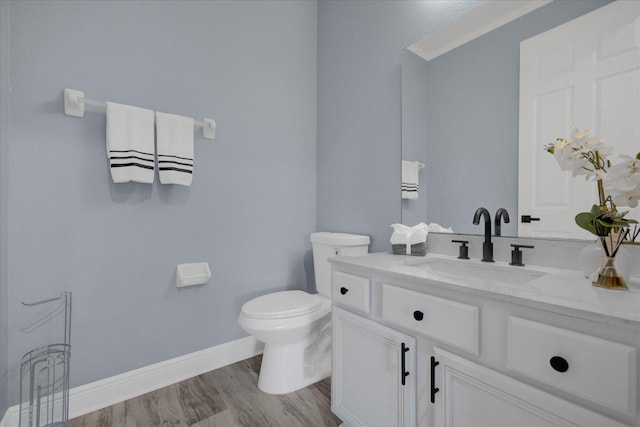 bathroom featuring hardwood / wood-style flooring, vanity, and toilet