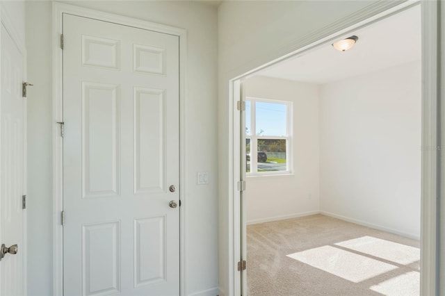 entryway with light colored carpet