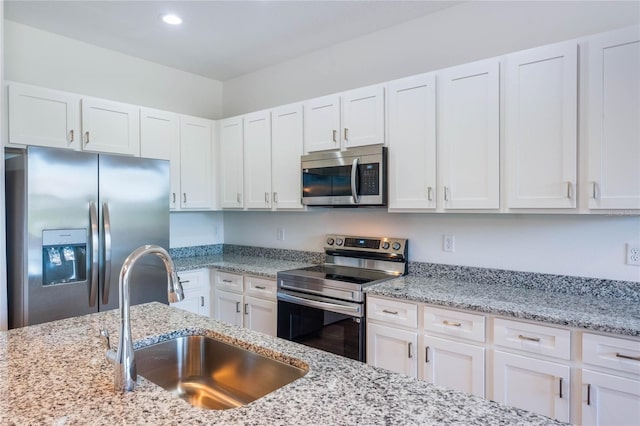 kitchen with sink, white cabinetry, and stainless steel appliances