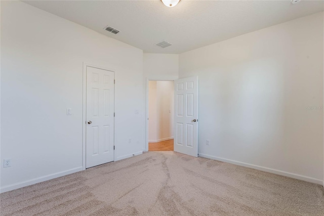 spare room with light carpet