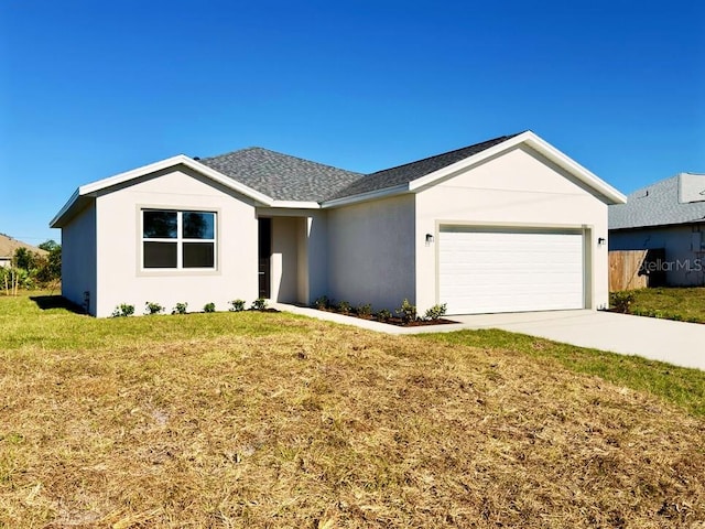 ranch-style house featuring a front yard and a garage