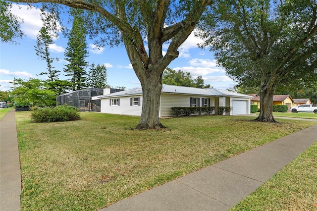 ranch-style home with glass enclosure, a garage, and a front yard