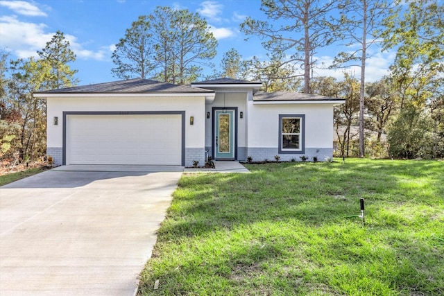 view of front of home with a front yard and a garage