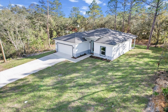 view of front of house with a front yard and a garage