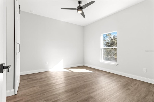 spare room featuring ceiling fan and dark wood-type flooring