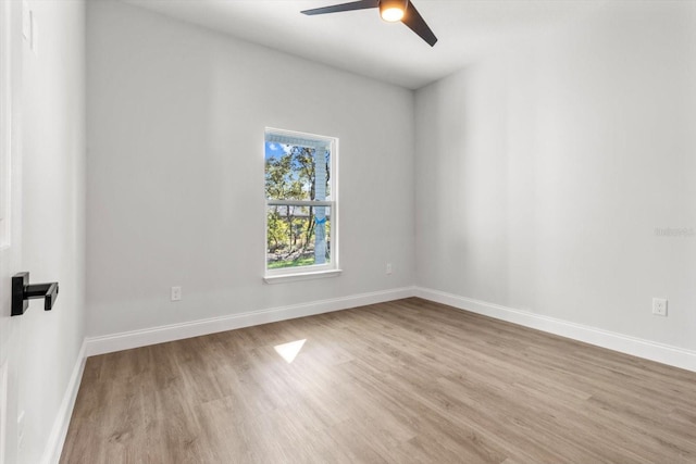 empty room featuring ceiling fan and light hardwood / wood-style floors