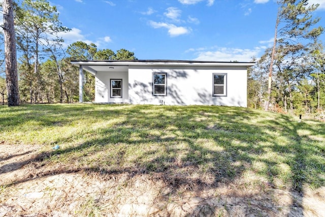 rear view of property with a yard