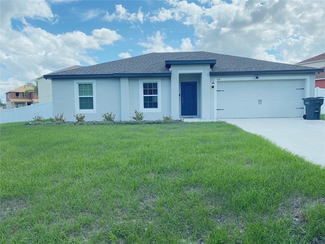 view of front of property with a garage and a front lawn