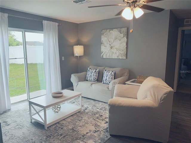 living room with wood-type flooring and ceiling fan