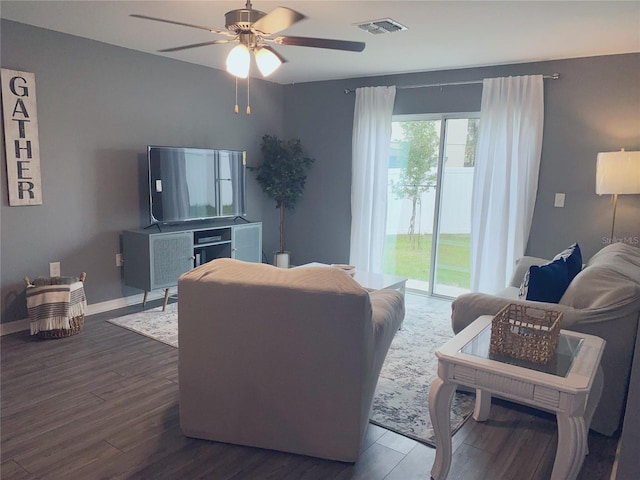 living room with dark hardwood / wood-style floors and ceiling fan