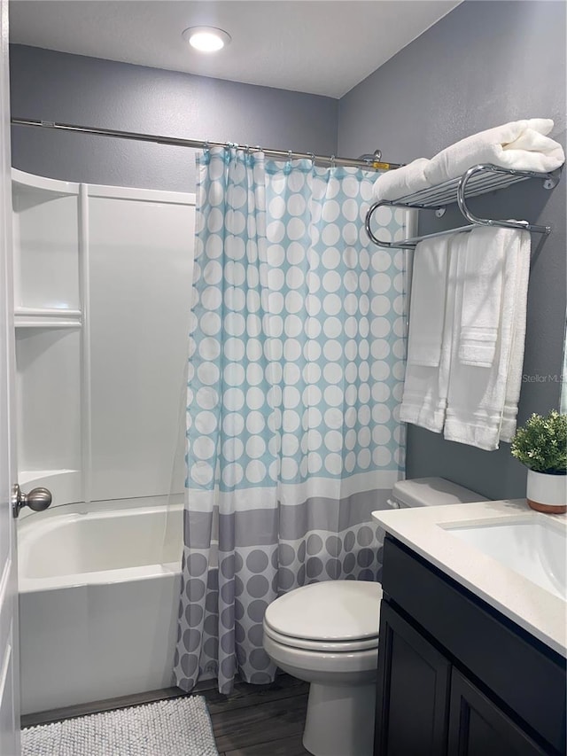 full bathroom with toilet, vanity, hardwood / wood-style flooring, and shower / tub combo with curtain