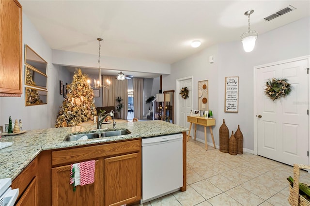 kitchen with kitchen peninsula, pendant lighting, white dishwasher, and sink