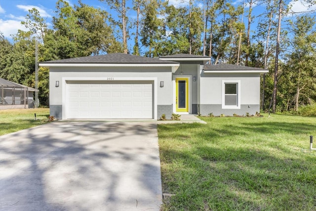 view of front facade with a garage and a front lawn