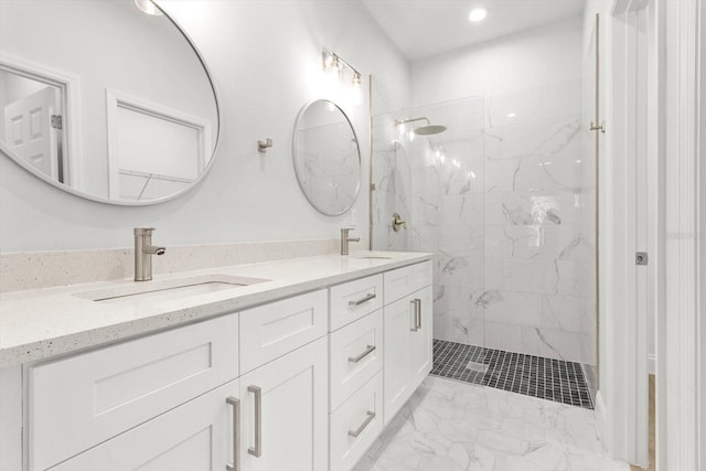 bathroom featuring a tile shower and vanity