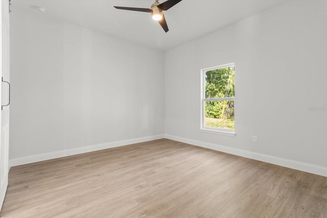 spare room featuring light hardwood / wood-style flooring and ceiling fan