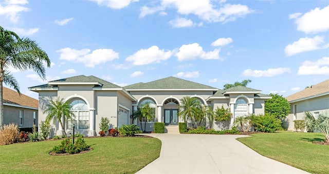 mediterranean / spanish-style home featuring french doors and a front lawn