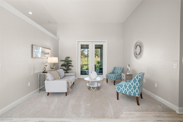 sitting room with light carpet and french doors