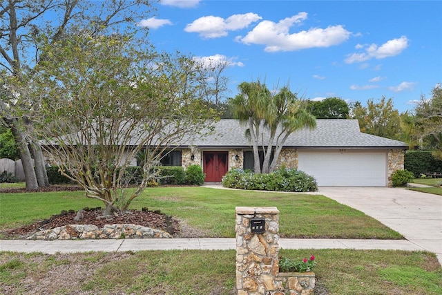 single story home featuring a front yard and a garage