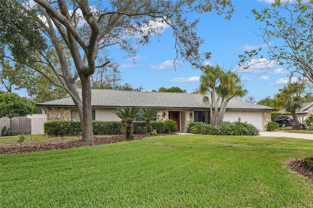 single story home featuring a front yard and a garage