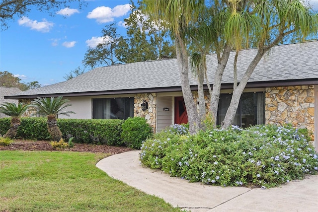 ranch-style home with a front lawn