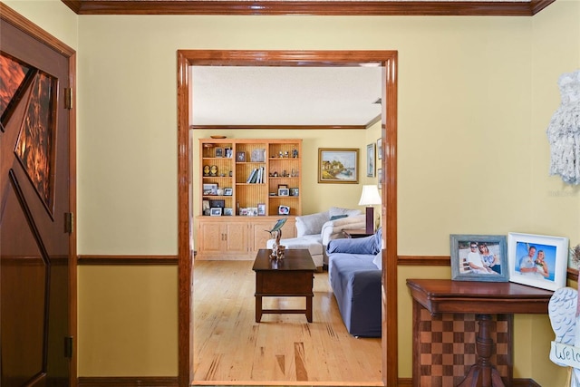 living room with crown molding and light hardwood / wood-style floors