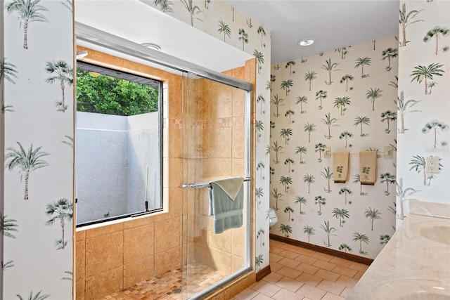 bathroom featuring toilet, vanity, tile patterned floors, and walk in shower