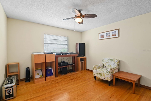 interior space featuring a textured ceiling, light hardwood / wood-style floors, and ceiling fan