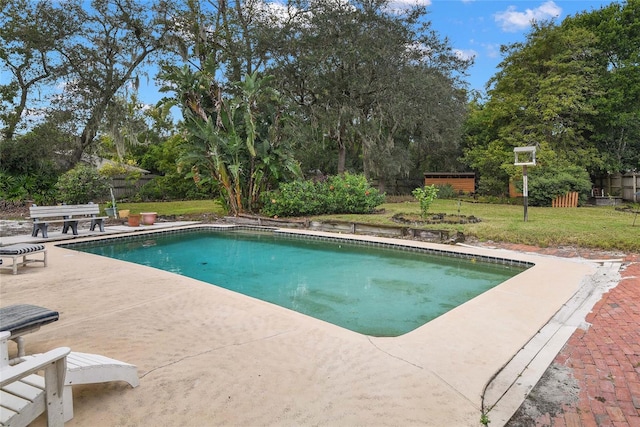 view of pool featuring a yard and a patio