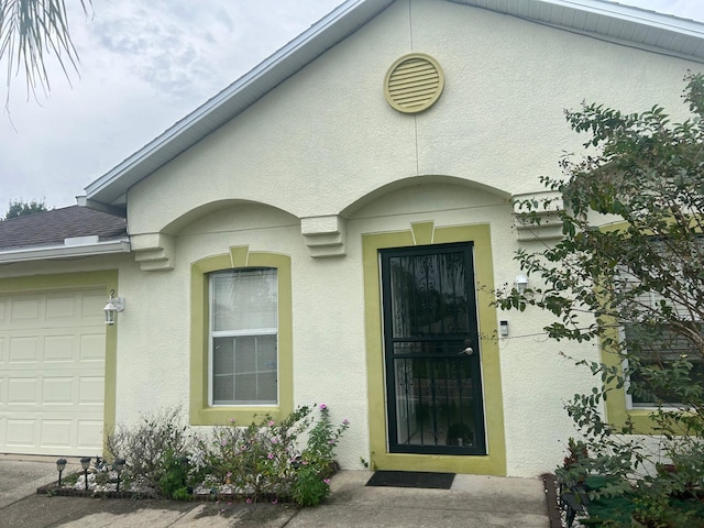 doorway to property with a garage