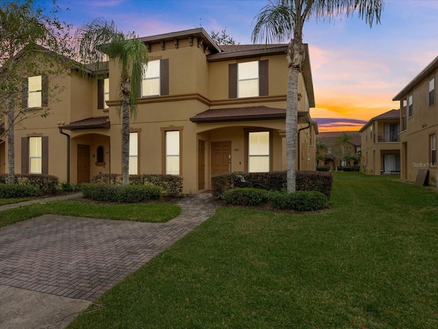 408 Miramar Ave, Davenport, FL 33897 - view of front of home with stucco siding and a lawn