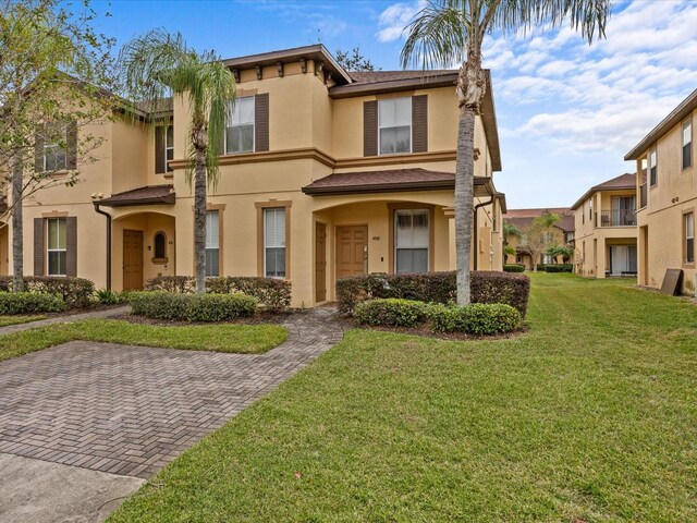 408 Miramar Ave, Davenport, FL 33897 - view of front of house featuring stucco siding, a front yard, and a residential view
