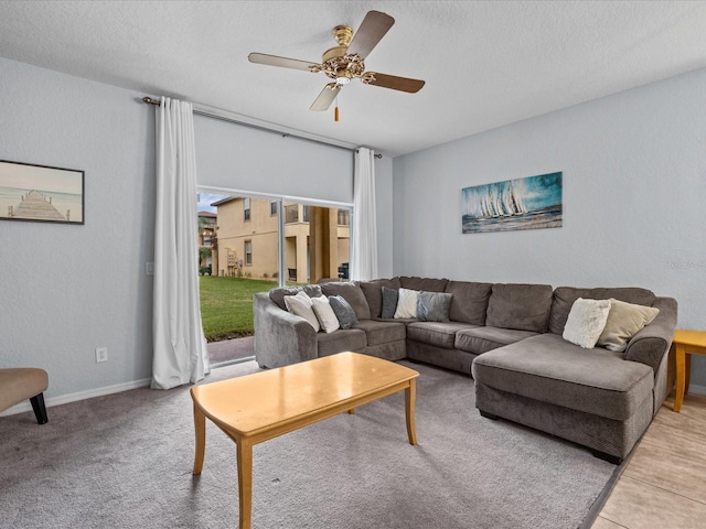 living room with light carpet, a textured ceiling, and ceiling fan