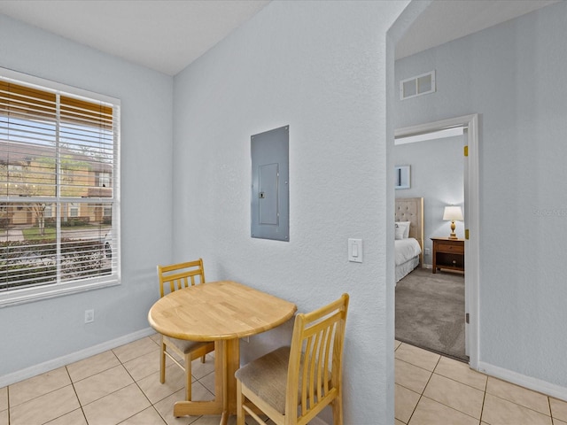 dining area with electric panel and light tile patterned floors