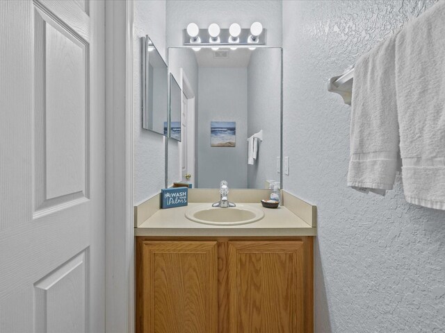 408 Miramar Ave, Davenport, FL 33897 - bathroom with a textured wall and vanity