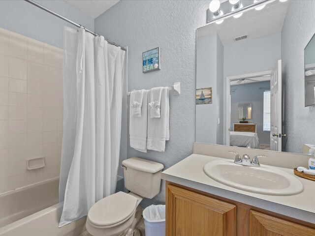 408 Miramar Ave, Davenport, FL 33897 - full bath featuring a textured wall, connected bathroom, vanity, shower / bath combination with curtain, and toilet