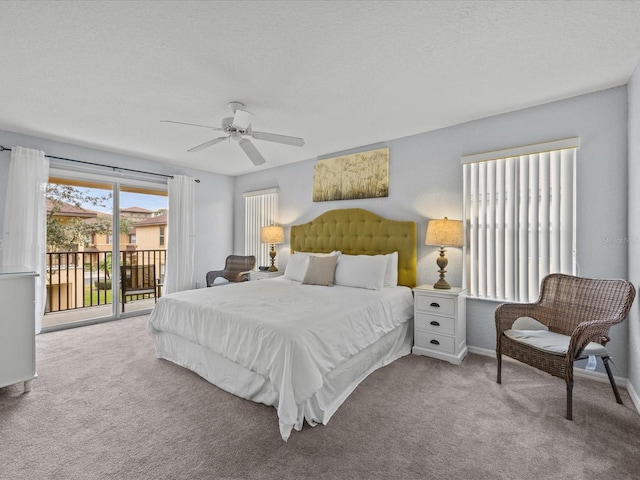 carpeted bedroom with access to exterior, ceiling fan, and a textured ceiling