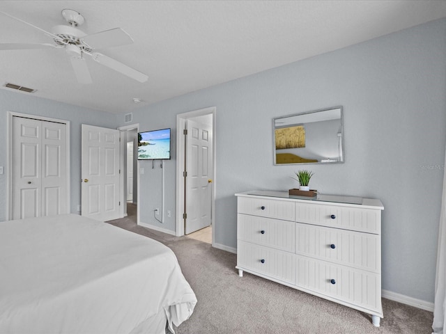 bedroom with ceiling fan, a closet, and light colored carpet