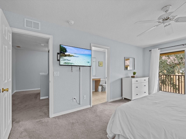 bedroom featuring ceiling fan, access to exterior, light carpet, and ensuite bath