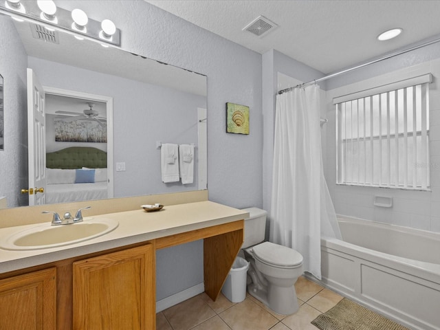 full bathroom featuring shower / bath combo with shower curtain, tile patterned flooring, vanity, and toilet