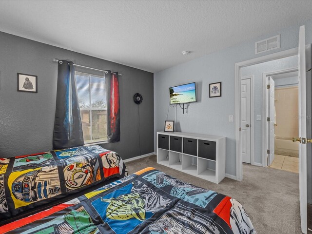 408 Miramar Ave, Davenport, FL 33897 - bedroom with a textured ceiling, carpet floors, and baseboards