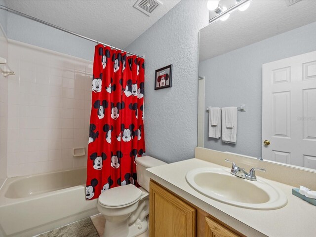 408 Miramar Ave, Davenport, FL 33897 - full bathroom with a textured wall, a textured ceiling, toilet, vanity, and shower / bath combo with shower curtain