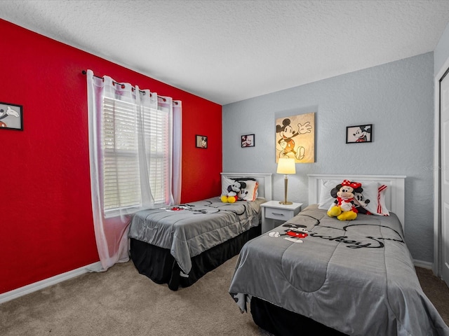 bedroom featuring carpet flooring and a textured ceiling