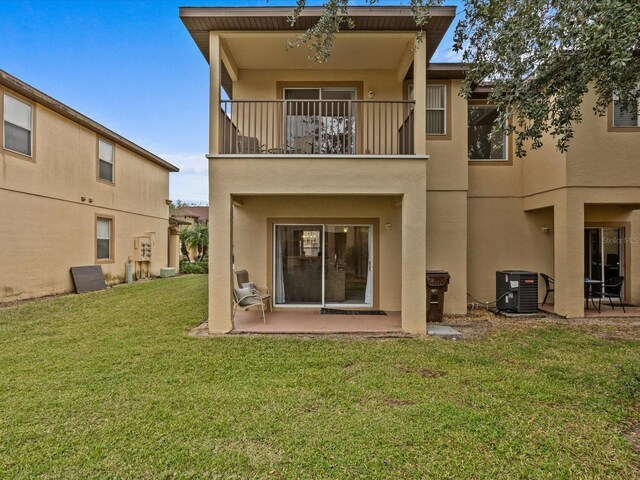 408 Miramar Ave, Davenport, FL 33897 - back of property featuring a balcony, stucco siding, central air condition unit, and a patio area