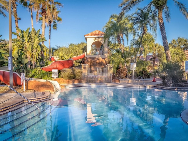 view of swimming pool with a water slide