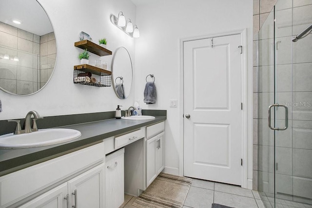 bathroom with tile patterned flooring, vanity, and walk in shower