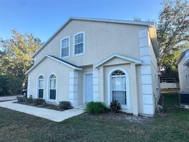 view of front of home featuring central AC unit and a front lawn