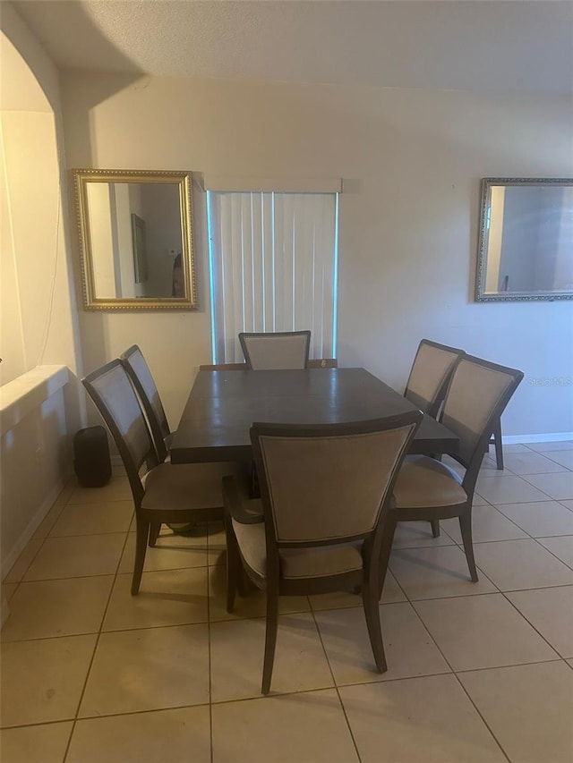 dining space featuring light tile patterned floors